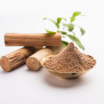 1-2 Taste IFF - Premium Sandal Fragrance sandalwood logs and finely ground powder in a brass bowl