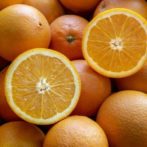 1-2 Taste IFF - Nagpur Orange Fragrance displayed with whole and halved fresh oranges showcasing juicy, vibrant citrus pulp