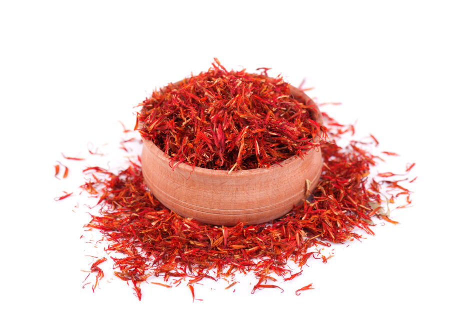Saffron spice in wood bowl isolated on white background