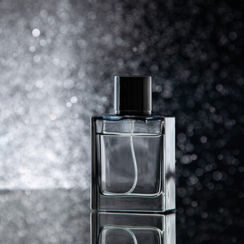 1-2 Taste IFF - Blacky Star Super Fragrance in a sleek black glass bottle with shimmering silver bokeh background, evoking elegance and luxury