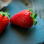 1-2 Taste IFF - Strawberry Flavour - S 4306 displayed as strawberry on a wooden table