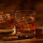 1-2 Taste IFF - Whisky Flavour - S 2789 shown as glasses of whiskey with ice cubes on a warm, moody background