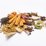 1-2 Taste IFF - All Spice Flavour - S 2064 displayed as an assortment of whole Indian spices including cinnamon sticks, cardamom, cloves, and black pepper on a white background