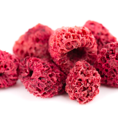 1-2 Taste Habit - Raspberry Dried displayed as close-up of freeze-dried raspberries, showcasing their airy, porous texture and vibrant red color on a white background
