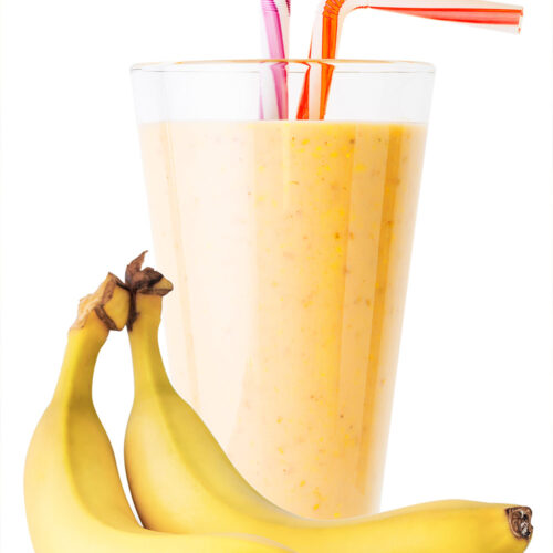 1-2 Taste Aroma INC - Banana Flavour Powder - O20208 shown as glass of creamy banana smoothie with fresh bananas and colourful straws on white background