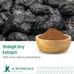 1-2 Taste JK Botanicals - Shilajit Dry Extract 50% Fulvic Acid by Gravimetry shown as dark powder in wooden bowl with raw shilajit chunks