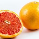 1-2 Taste Aroma INC - Natural Grapefruit Flavour - O20212 shown as Whole and halved fresh grapefruit with vibrant pink flesh on white background