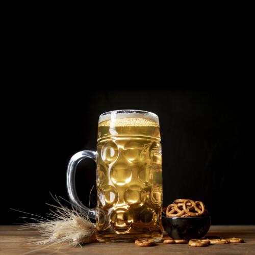 1-2 Taste Aroma INC - Natural Beer Bock Mix Flavour - S21030 represented as glass mug of golden beer with frothy head, paired with a bowl of pretzels and barley on wooden table