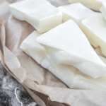 1-2 Taste JS Cocoa - Refined Cocoa Butter POLAR™, shown as smooth, white cocoa butter chunks placed on parchment paper