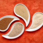 1-2 Taste Blonk Quality Ingredients - Teff Flour Fine Brown shown as assorted teff flour varieties in elegant white dishes on a vibrant orange background