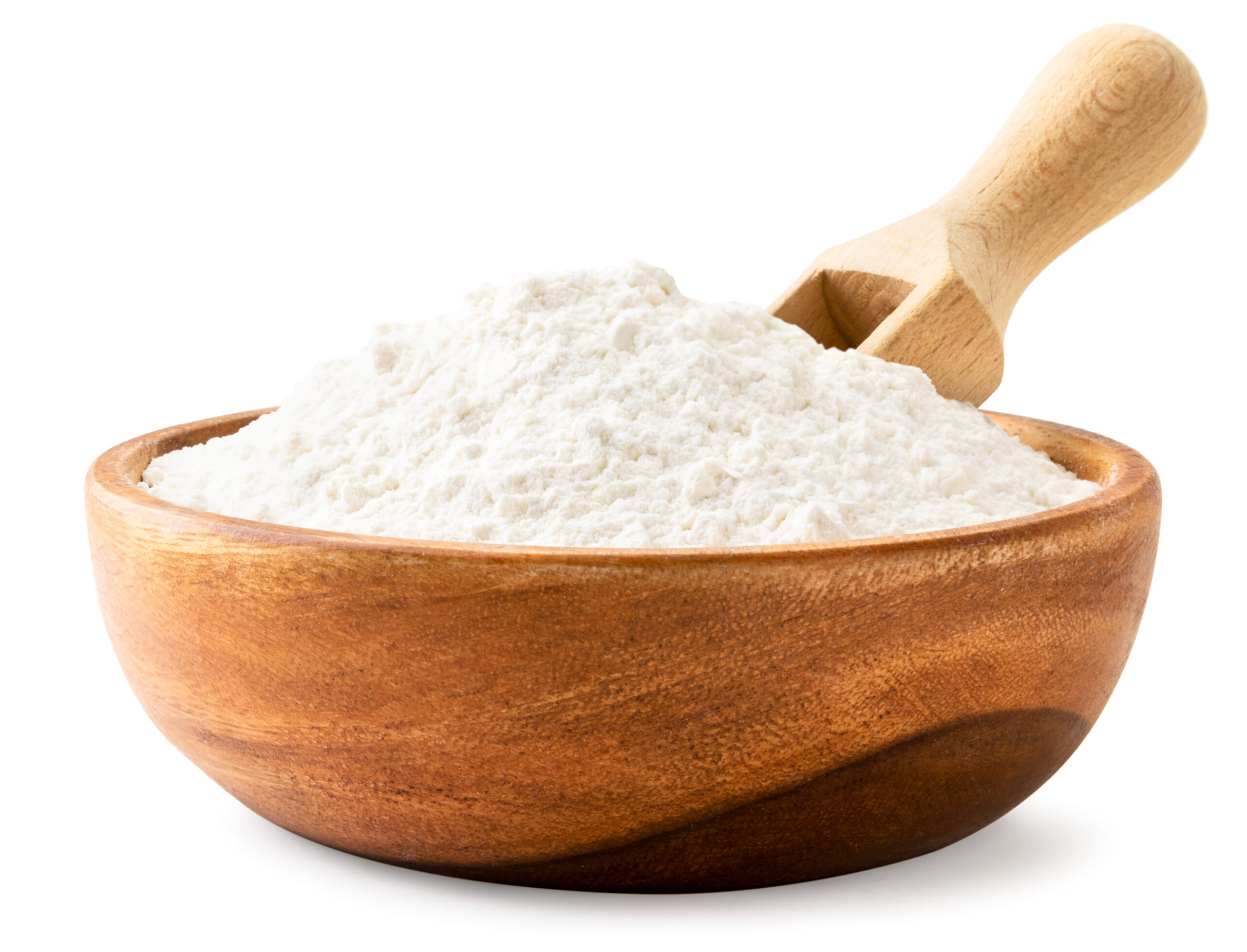 Flour in a wooden plate with a scoop on a white background. Isolated