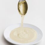 A bowl of AllSWEET® Allulose Syrup, a low-calorie, non-GMO sweetener for reducing sugar in food products and supporting KETO and diabetic-friendly formulations. Allulose syrup vs maple syrup and other sweeteners comparisson is important to select the best one for food manufacturing.