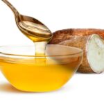 1-2 Taste FiberSMART Tapioca Syrup 90% dripping from spoon into bowl beside fresh tapioca
