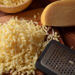 1-2 Taste Trigona - Gouda Young Grated on wooden board with metal grater and cheese block