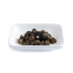 Trufo – Black Summer Truffle Cubes (5x5x5 mm) neatly arranged on a white rectangular dish, showcasing uniformly diced truffle pieces with a rich, dark texture