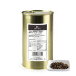 1-2 Taste Trufo - Black summer Truffle Brisure 7% packaged in a gold tin, labeled with ingredient and nutrition details, alongside a white dish displaying the coarsely chopped truffle blend