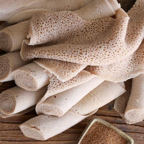 1-2 Taste Blonk Quality Ingredients - Brown Teff Flour for Injera shown as traditional Ethiopian Injera rolls made from teff flour on rustic wooden surface