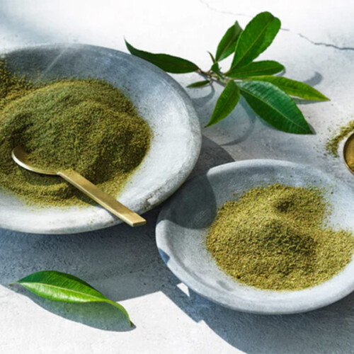 1-2 Taste Lemon Myrtle Dried Leaf Fine Cut in stone bowls with green leaves, USDA Organic certified
