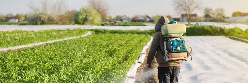 farmer spraying pesticides