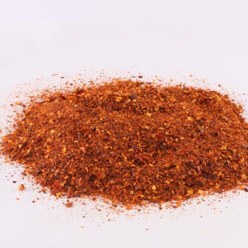1-2 Taste Dace - Organic Chilli Flakes shown as coarse red pepper flakes with visible seeds on a clean pink background