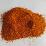 1-2 Taste Dace - Organic Chilli Powder shown as finely ground bright red-orange spice on a white background