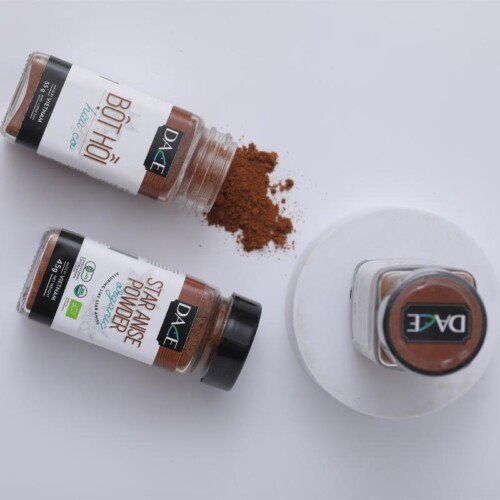 1-2 Taste Dace - Organic Star Anise Powder in spice jars with scattered powder on white background