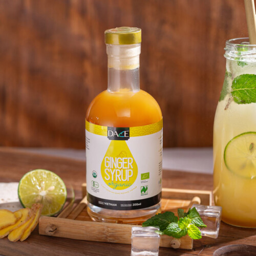 1-2 Taste Dace - Organic Ginger Syrup displayed as a bottle with label and fresh lime, mint, and iced ginger drink beside