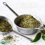 1-2 Taste Organic Lemon Myrtle Dried Leaf Extra Coarse Cut in rustic metal measuring cups with USDA Organic label